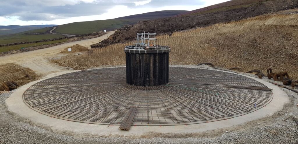 Construction of wind turbine base showing concrete and steel fixing at Dorenell Wind Farm